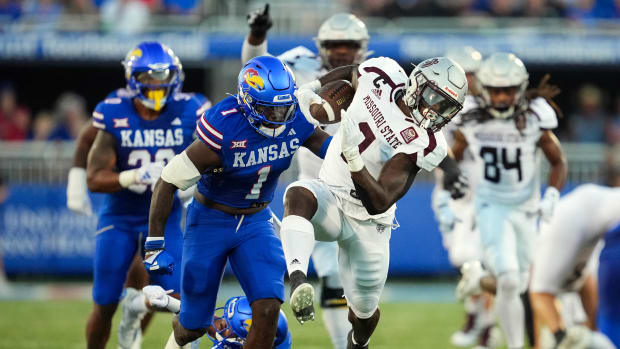 Sep 1, 2023; Lawrence, Kansas, USA; Missouri State Bears running back Jacardia Wright (9) runs the ball against Kansas Jayhawks safety Kenny Logan Jr. (1) during the first half at David Booth Kansas Memorial Stadium. Mandatory Credit: Jay Biggerstaff-USA TODAY Sports  